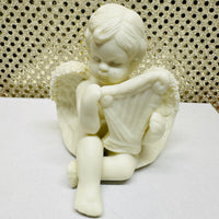 
              Four Porcelain Cherubs Playing Instruments
            