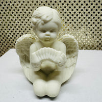 
              Four Porcelain Cherubs Playing Instruments
            