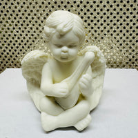 
              Four Porcelain Cherubs Playing Instruments
            