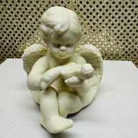 
              Four Porcelain Cherubs Playing Instruments
            