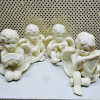 Four Porcelain Cherubs Playing Instruments
