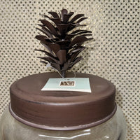 
              Glass Jar with Metal Pine Cone Lid
            