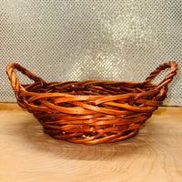 
              Stained Wicker Round Basket with Braided Handles
            