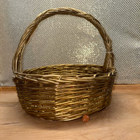 
              Gold Painted Round Handled Wicker Basket
            